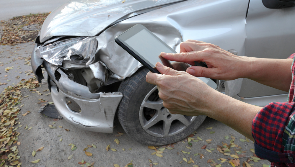 A person gathers information before dealing with the at-fault driver's insurance company after an accident. 